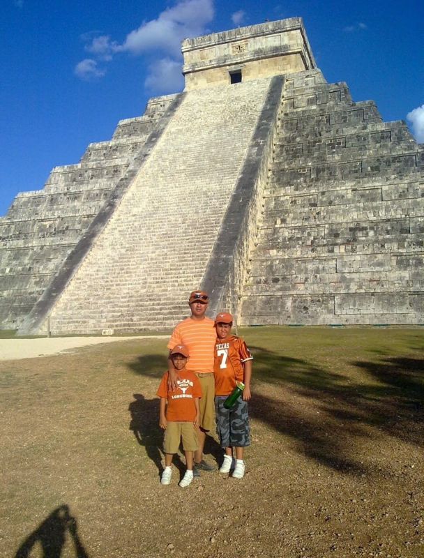 A family in front of the El Castillo pyramid at Chichen Itza