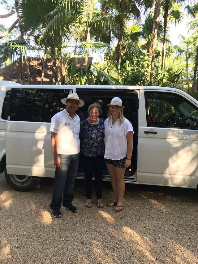 Julian with two smiling guests in front of the Yakata van